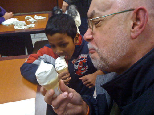 Bob Bruce shows Din Wan, a recent Burmese immgrant, how to eat an ice cream cone.