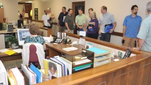 Bishop Phil Whipple (far right) giving a tour of the offices to the Church History class. At their workstations are Cathy Reich (left, administrative assistant to the bishop), and Darlene Burkett (administrative assistant in Global Ministries).