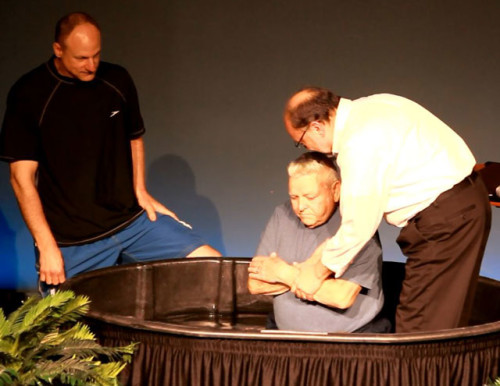 Pastor Mike Caley (right) performing one of the days 23 baptisms.