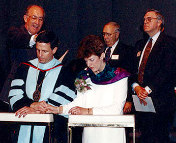 Bishop C. Ray Miller (left) conducting the inauguration of Dr. Dowden in 1991 (kneeling, with wife Chris).