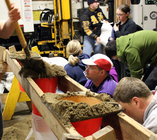 Huntington University students filling sandbags.