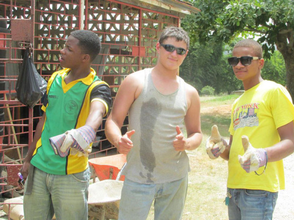 Salem teens with one of the Jamaican workers.