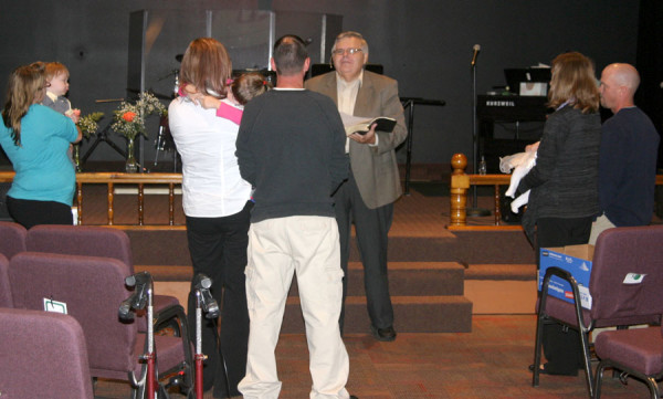Pastor Mark Ralph leading in three baby dedications.
