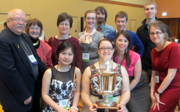 HU Alpha Chi members with the President's Cup trophy. On the left is Dr. Paul Michelson, a History professor at HU, who has long been an Alpha Chi sponsor.
