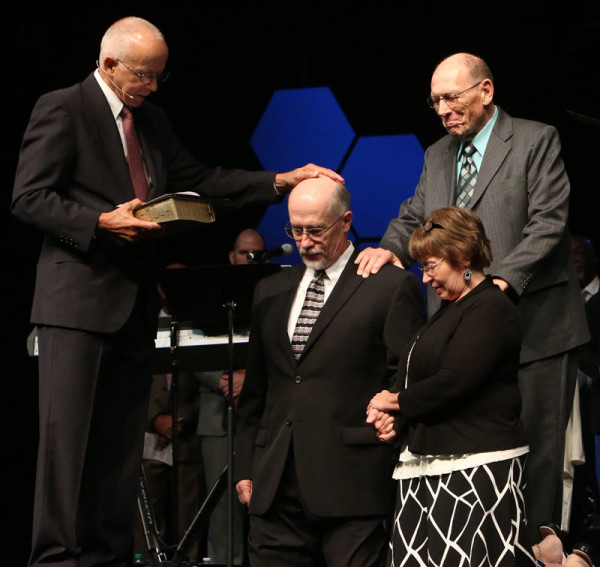 The ordination of Bill Blue, with his wife, Charlene. Rev. Carlson Becker is standing behind them.