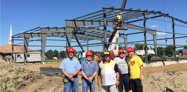 Pictured in front of the steel being erected on July 30 are (l-r): Doug Davisson (job site superintendent from Midwest Church Construction), Cliff Iles (Lake View Church project manager), Steve Smith (senior pastor), Duane Knisely (co-chairman of Expansion Team), and Ben Gladhill (associate pastor).